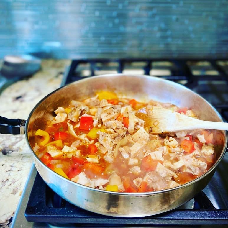 Pan with chopped up chicken and tomato with lovejoys brand bloody mary mix 