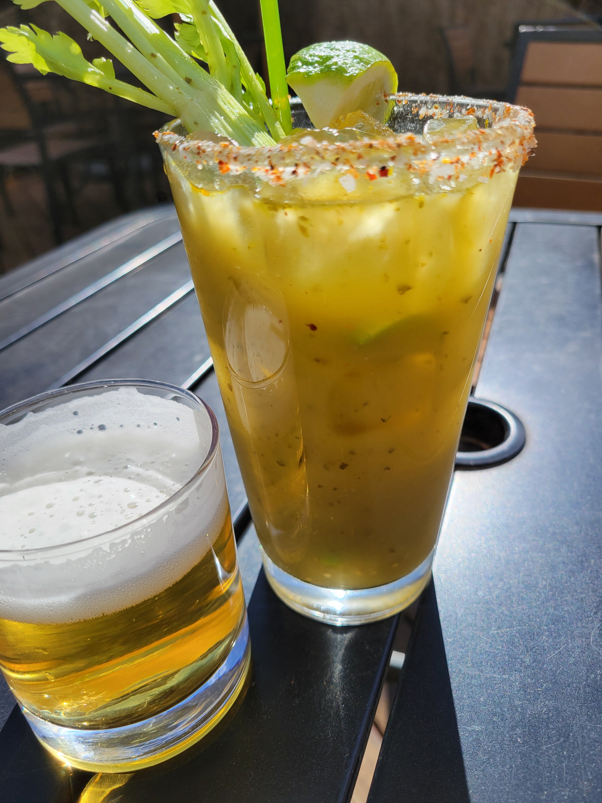 Glass of Lovejoy's Chimichurri Bloody Mary Mix on outside patio table.