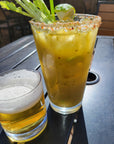 Glass of Lovejoy's Chimichurri Bloody Mary Mix on outside patio table.