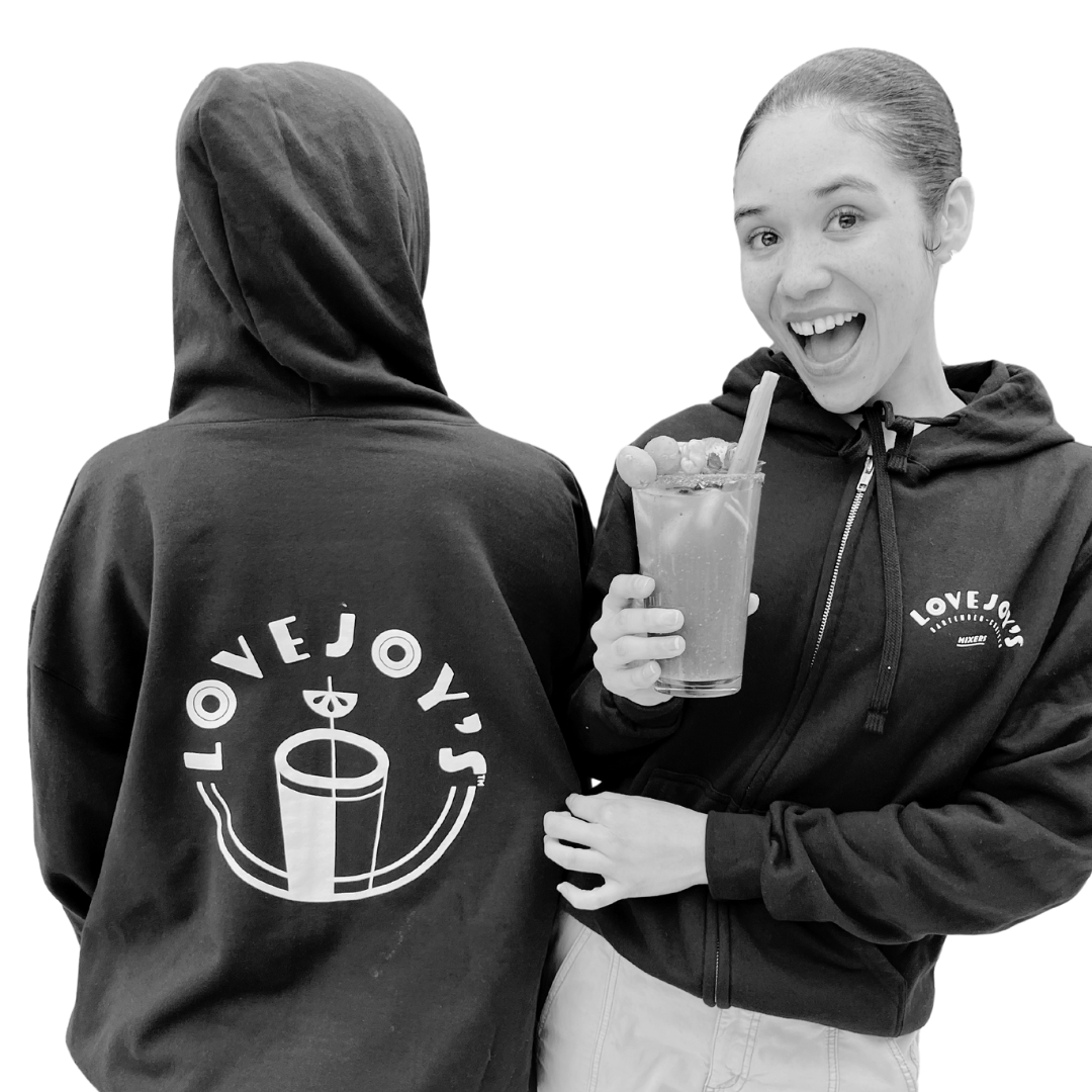 Woman wearing Lovejoy's sweatshirt while sipping a bloody mary.