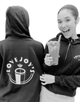 Woman wearing Lovejoy's sweatshirt while sipping a bloody mary.