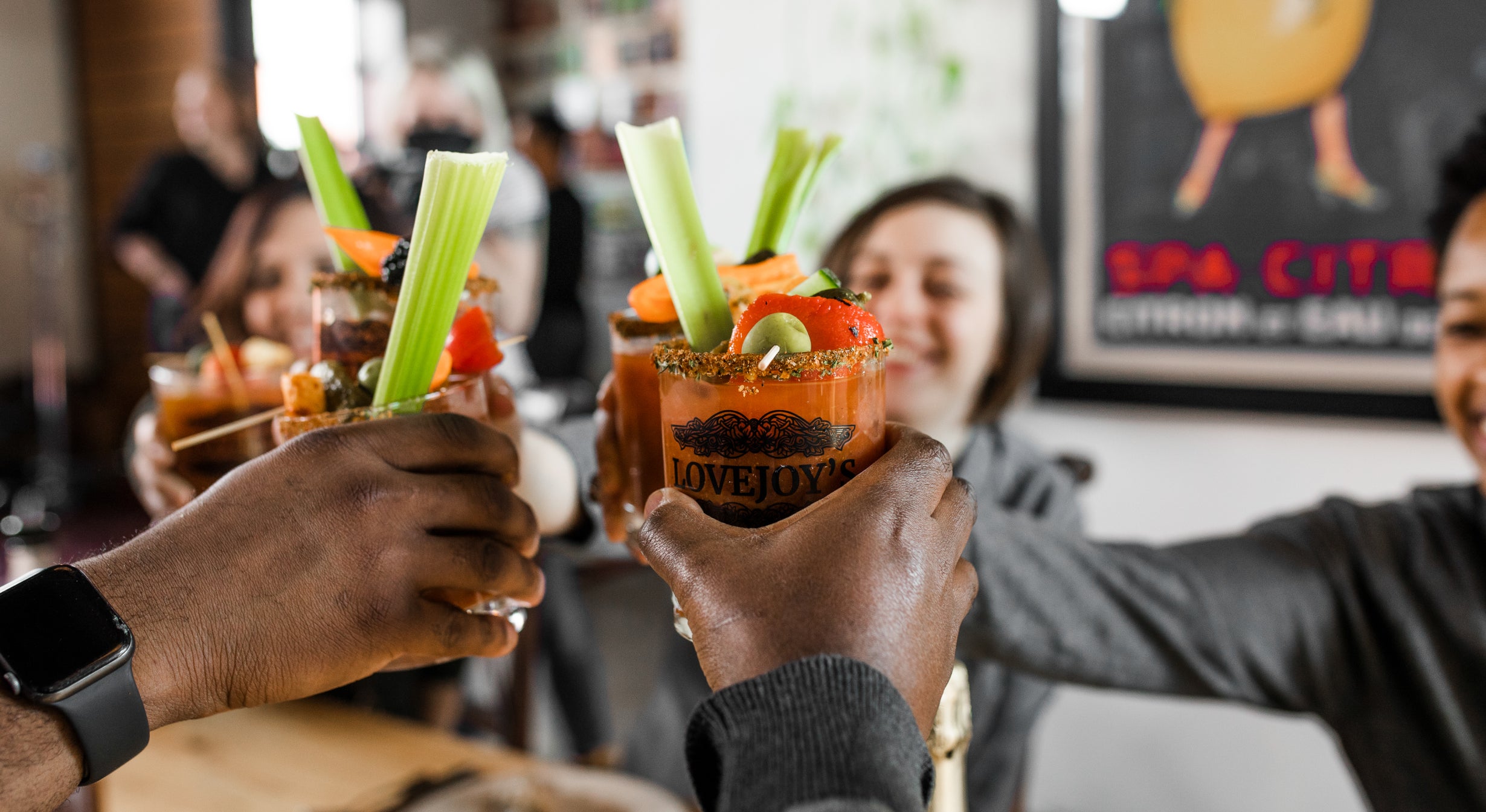 People toasting with Lovejoy's Bloody Marys.