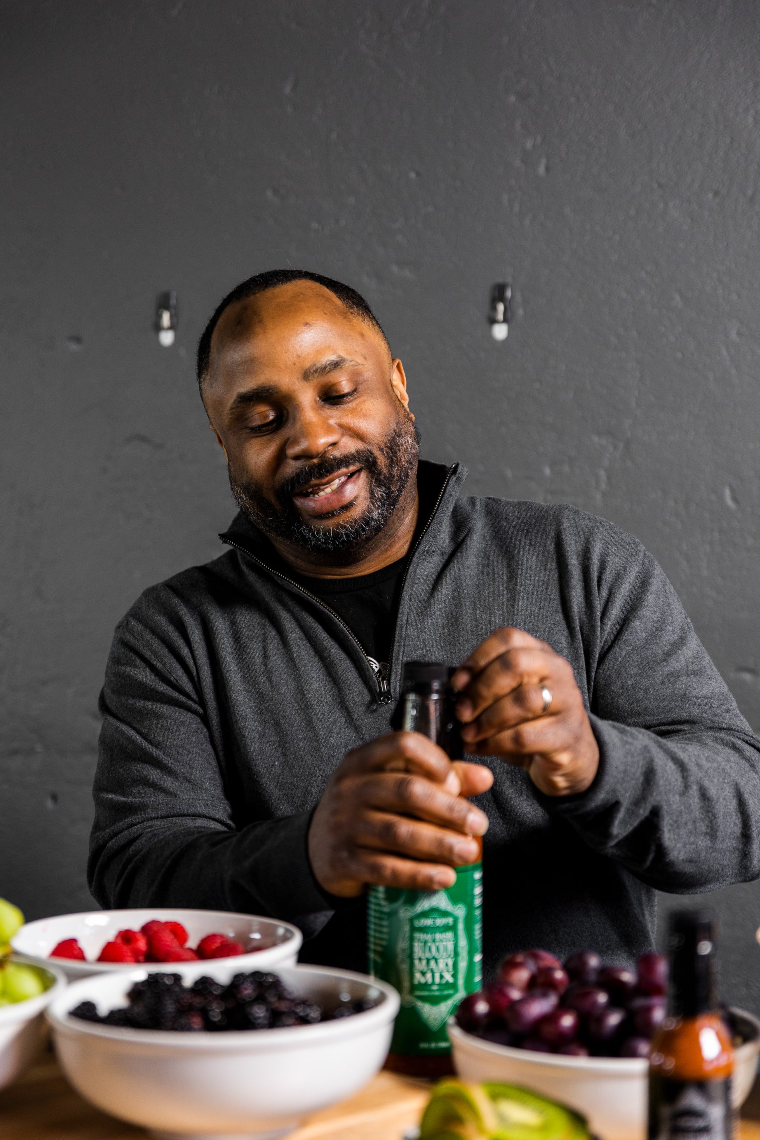 Founder Charles Lovejoy opening a bottle of bloody mary mix.